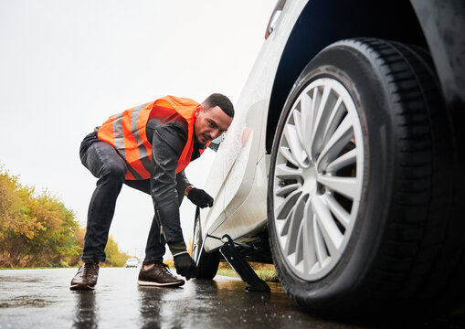 Mechanic assisting with a car wheel